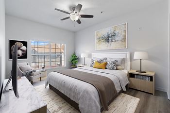 a bedroom with a bed and a ceiling fan